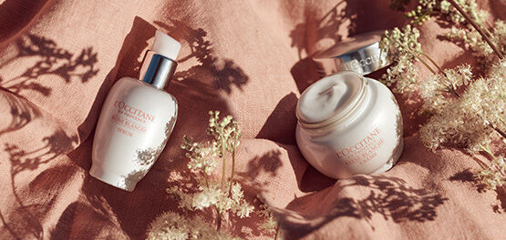 Reine Blanche brightening cream and serum on blanket